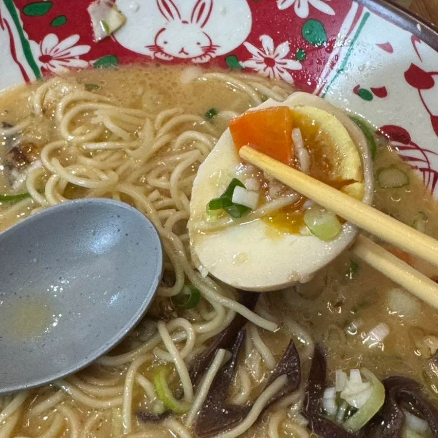 Bowl of tonkotsu ramen topped with char siu and soft-boiled egg