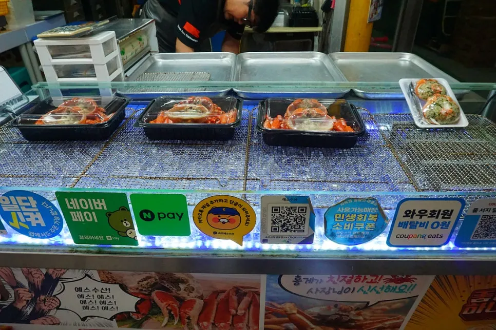 Display case with red snow crab lunchboxes at Yes Susan