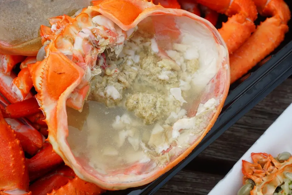 Red snow crab leg meat set beside the rice ball