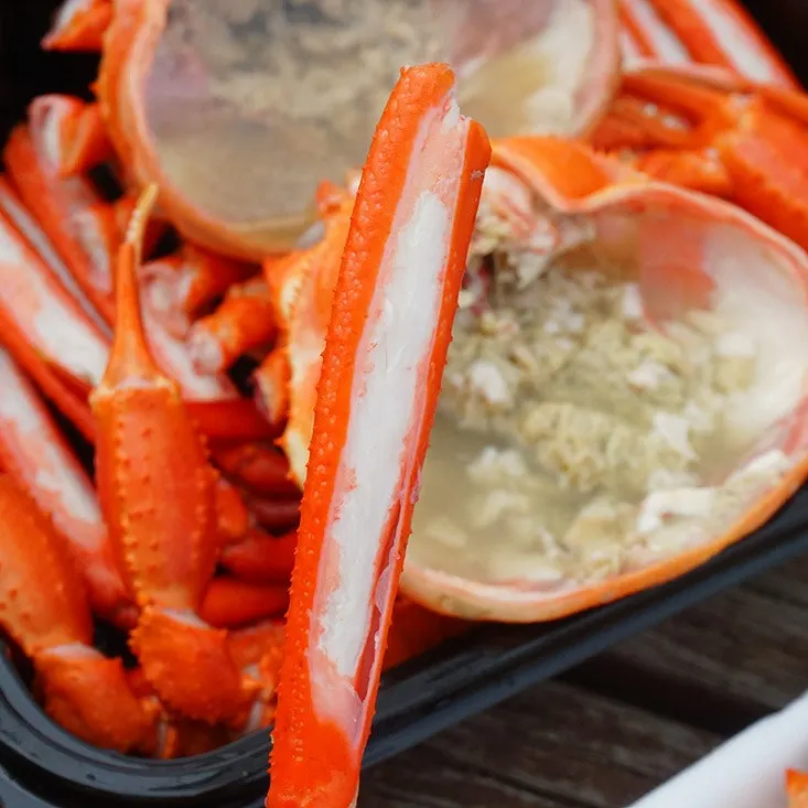 Scraping the crab guts out with a spoon