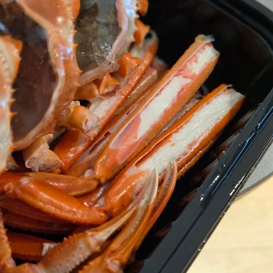 Market food and the red snow crab lunchbox spread out on the hotel table