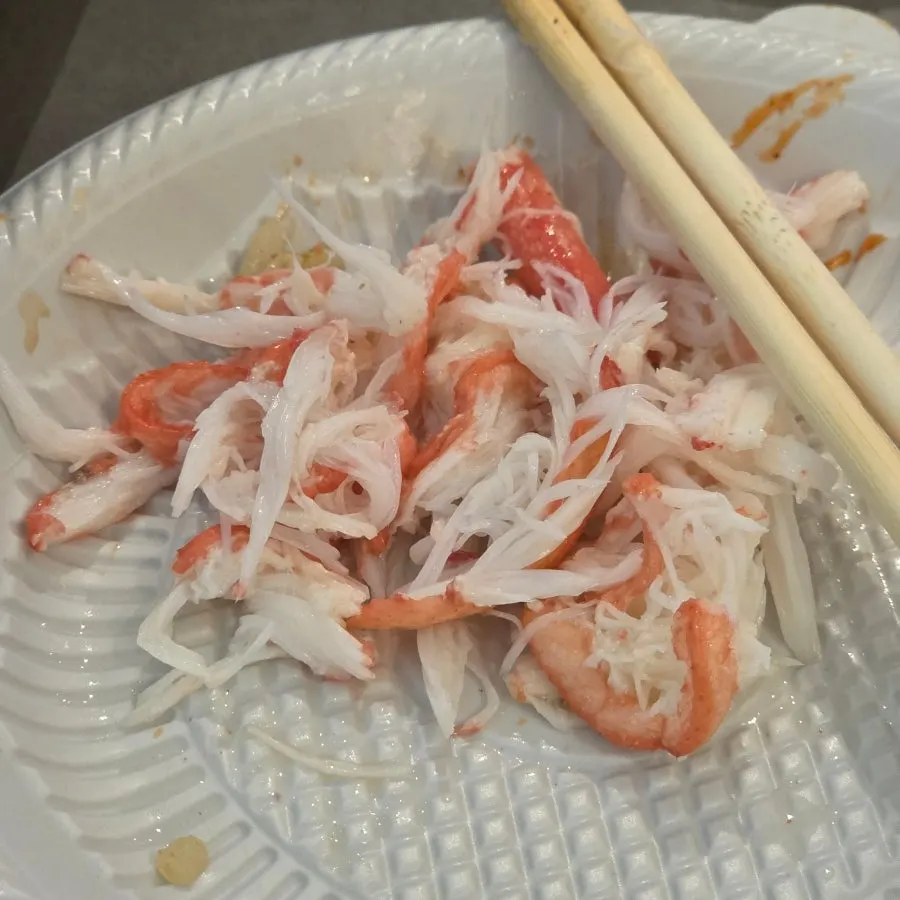 Picking red snow crab meat while wearing latex gloves