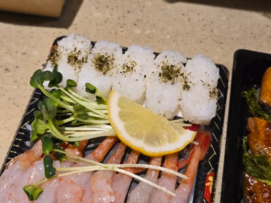 Sushi rice packed alongside the sweet shrimp sashimi