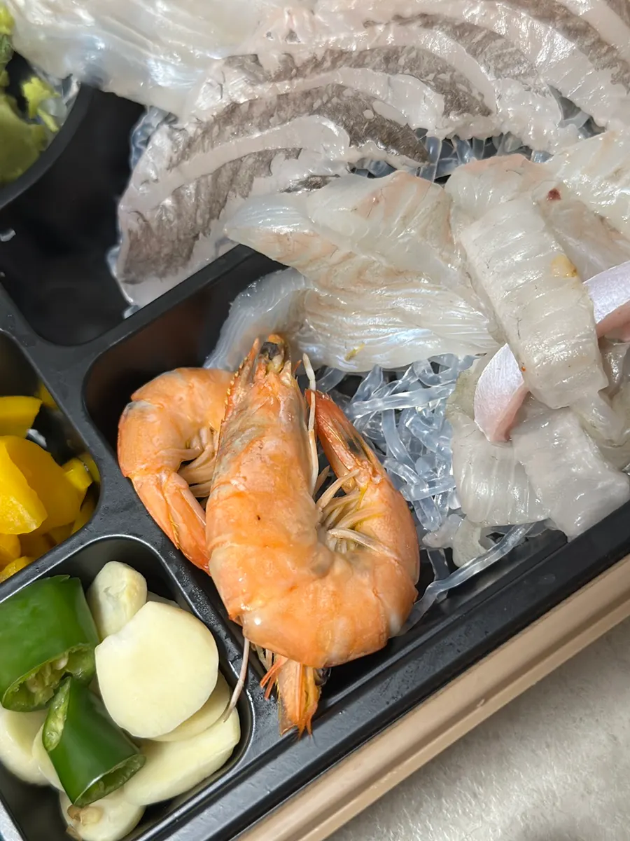 Two shrimp included in the sashimi box