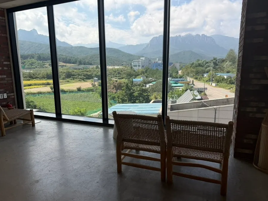 Seating by the floor-to-ceiling windows at Cafe Neorae
