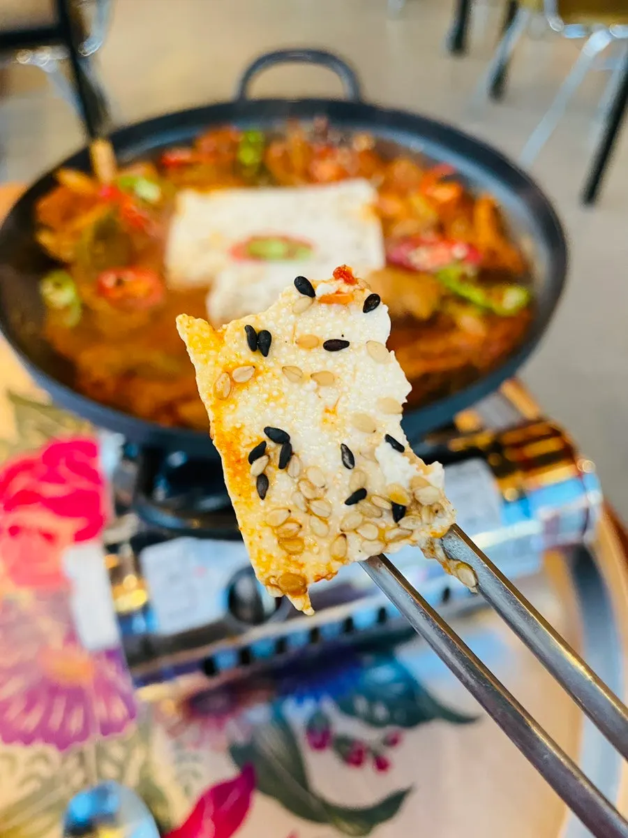 A bite of kimchi, meat, and cheongyang chili