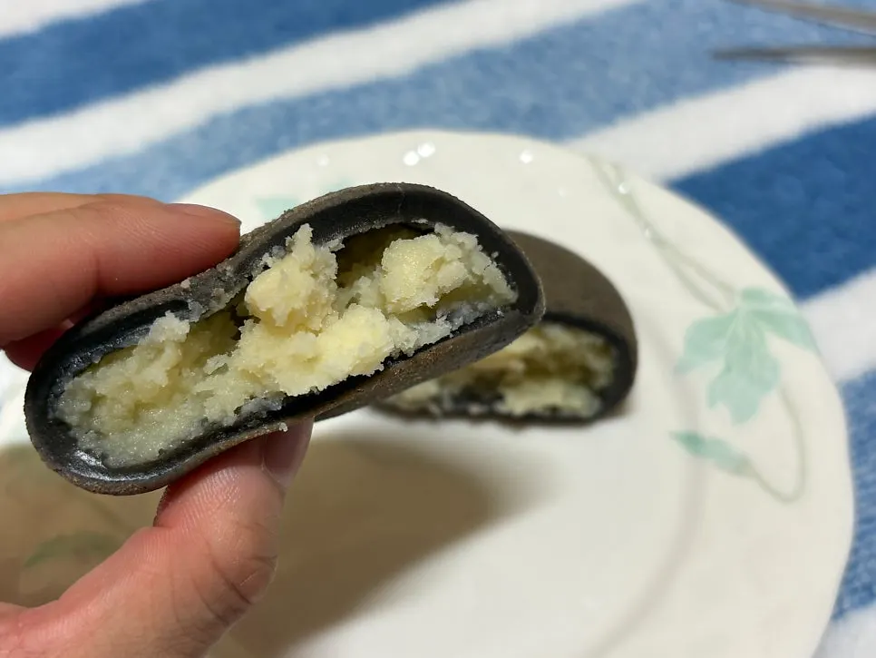 Dense potato filling inside the heated bread