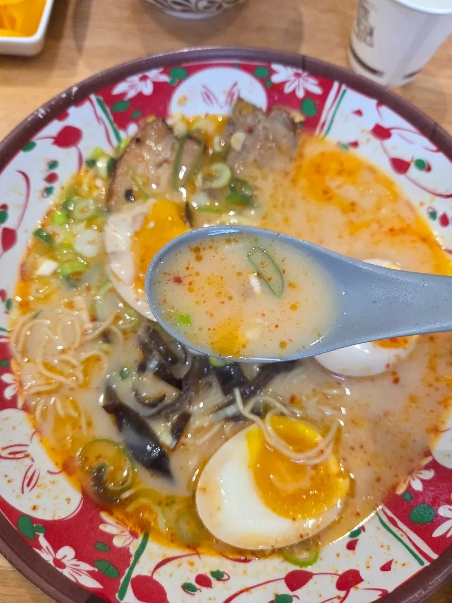 Ramen noodles lifted with chopsticks