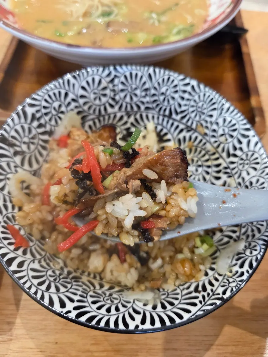 A bite of butadon topped with chashu and ginger