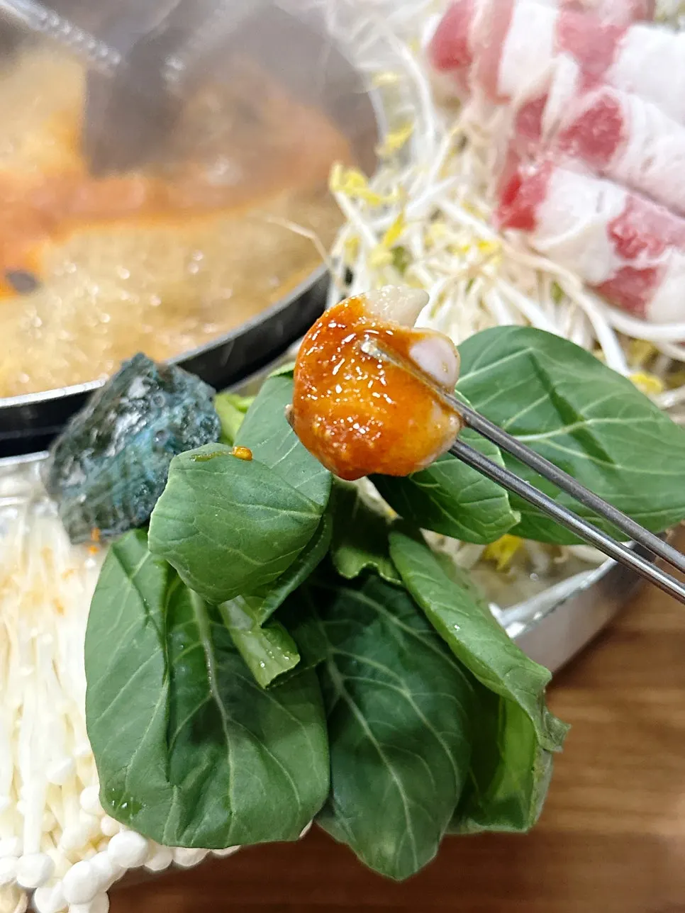 Thinly sliced beef shabu placed on top of bean sprouts