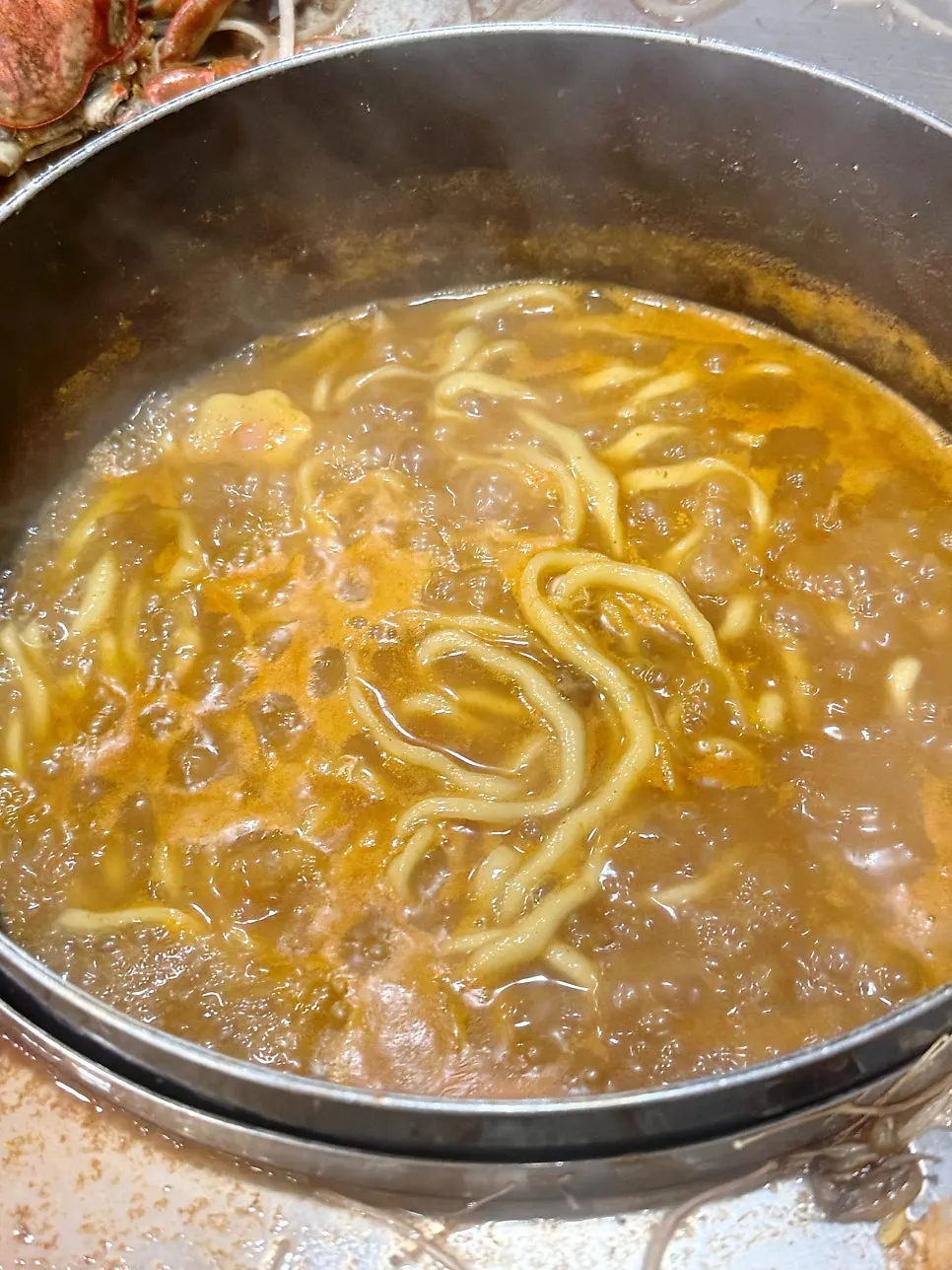 Thick kalguksu noodles added into the seafood broth