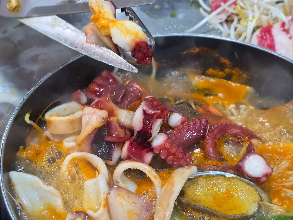 Plate with cooked seafood pulled out of the pot