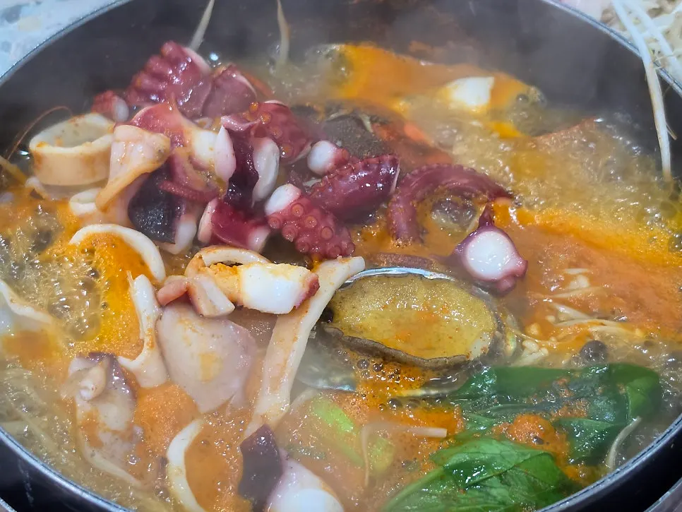 Jangkalguksu broth boiling with a spicy kick