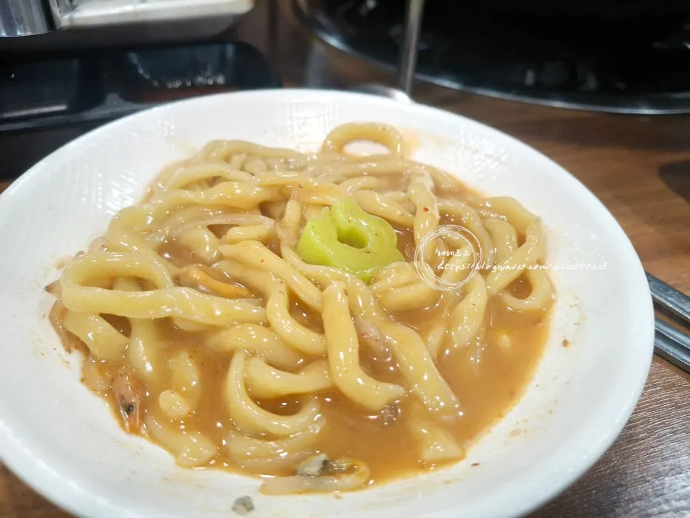 House-made fresh noodles simmering in the broth
