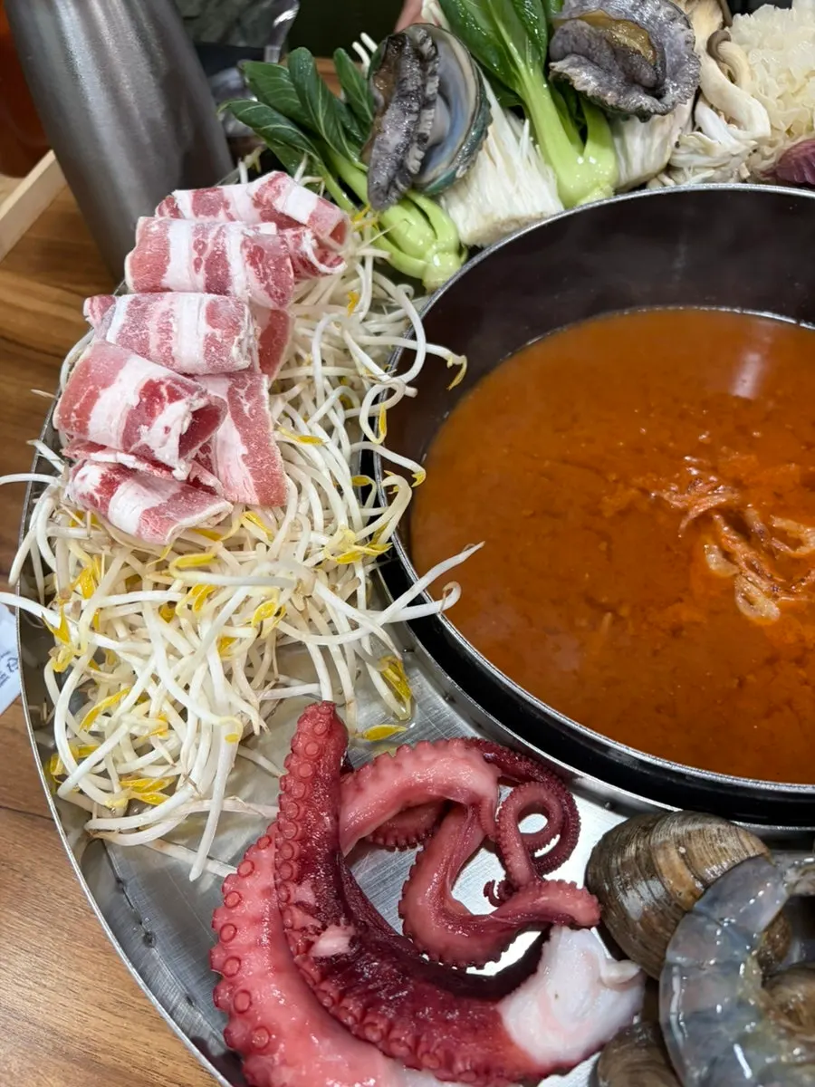 Seafood platter topped with whole squid, octopus, and abalone