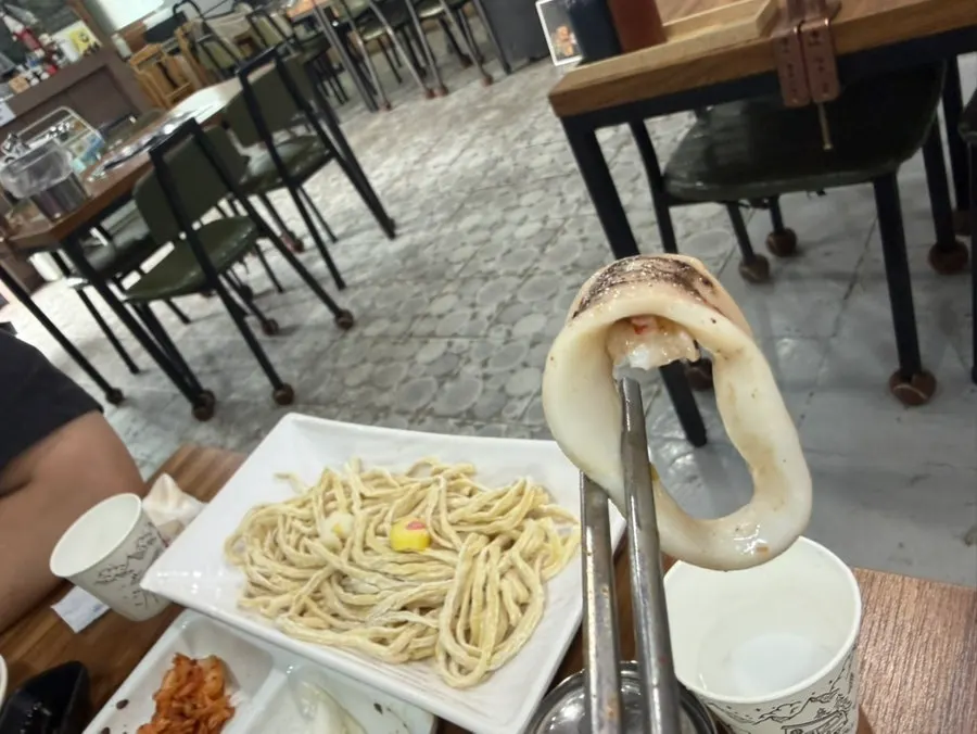 Whole squid added to the pot