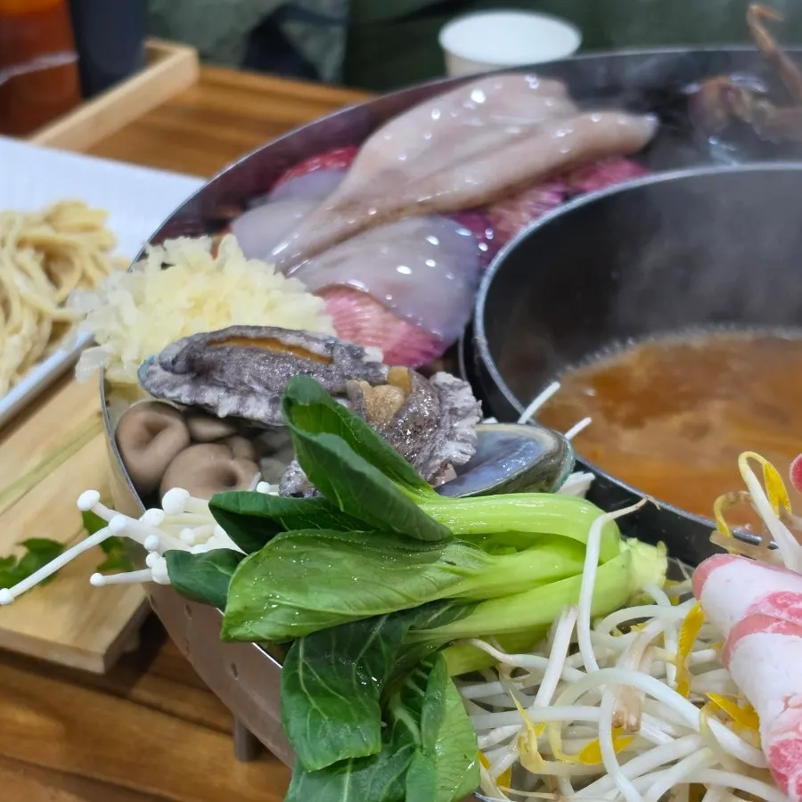 Broth simmering with seafood and vegetables