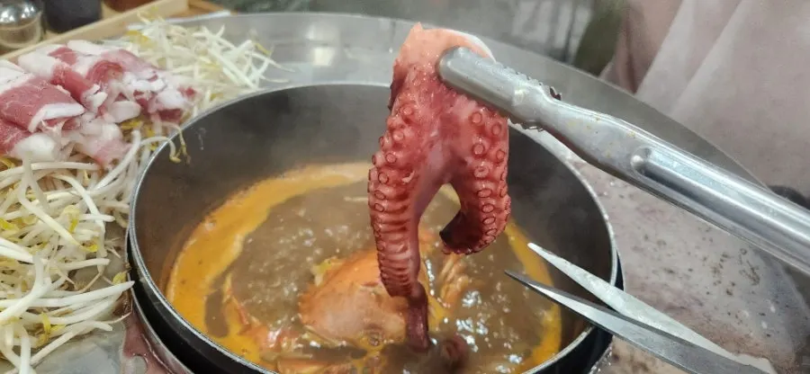 Whole squid and oyster mushrooms poached in broth