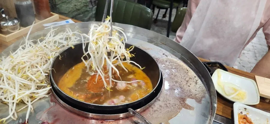 Shabu broth simmering with blue crab
