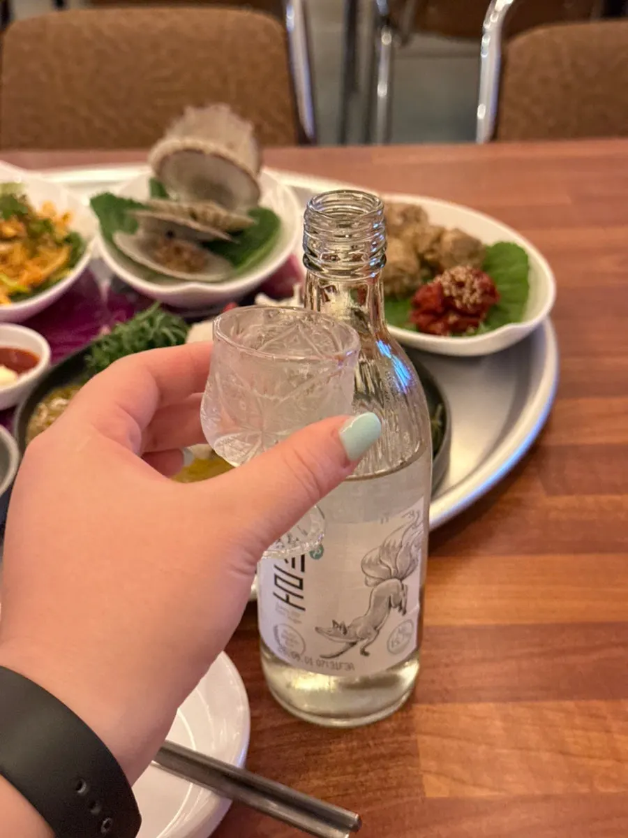 Soju glasses set beside the drinking snacks