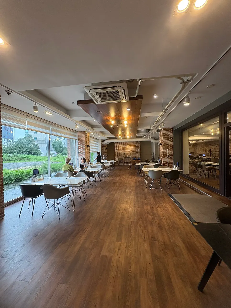 Dining hall with floor-to-ceiling windows letting in natural light