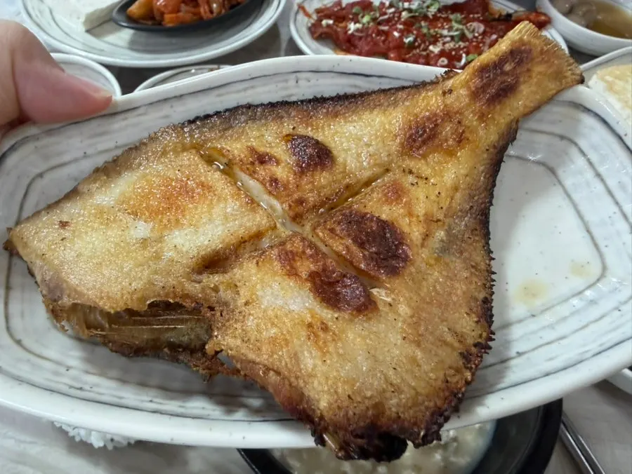 A plate of fried flounder served with the meal