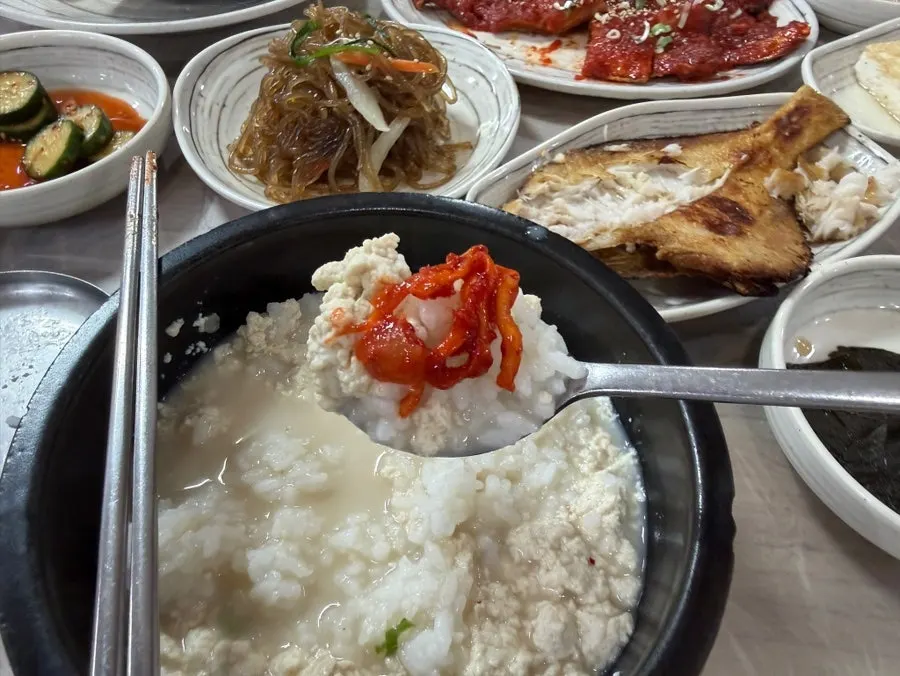A bowl of sundubu with rice mixed in, topped with salted squid