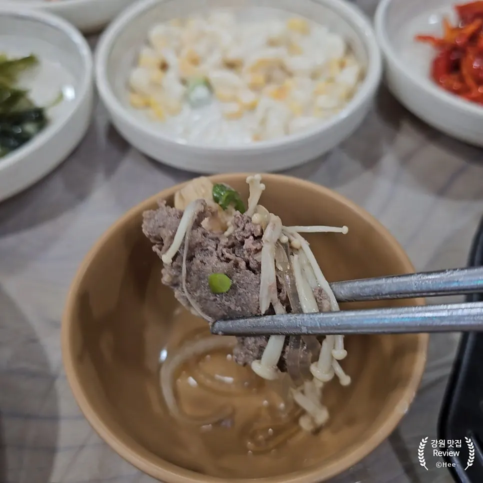 Table set with both spicy sundubu and bulgogi baekban