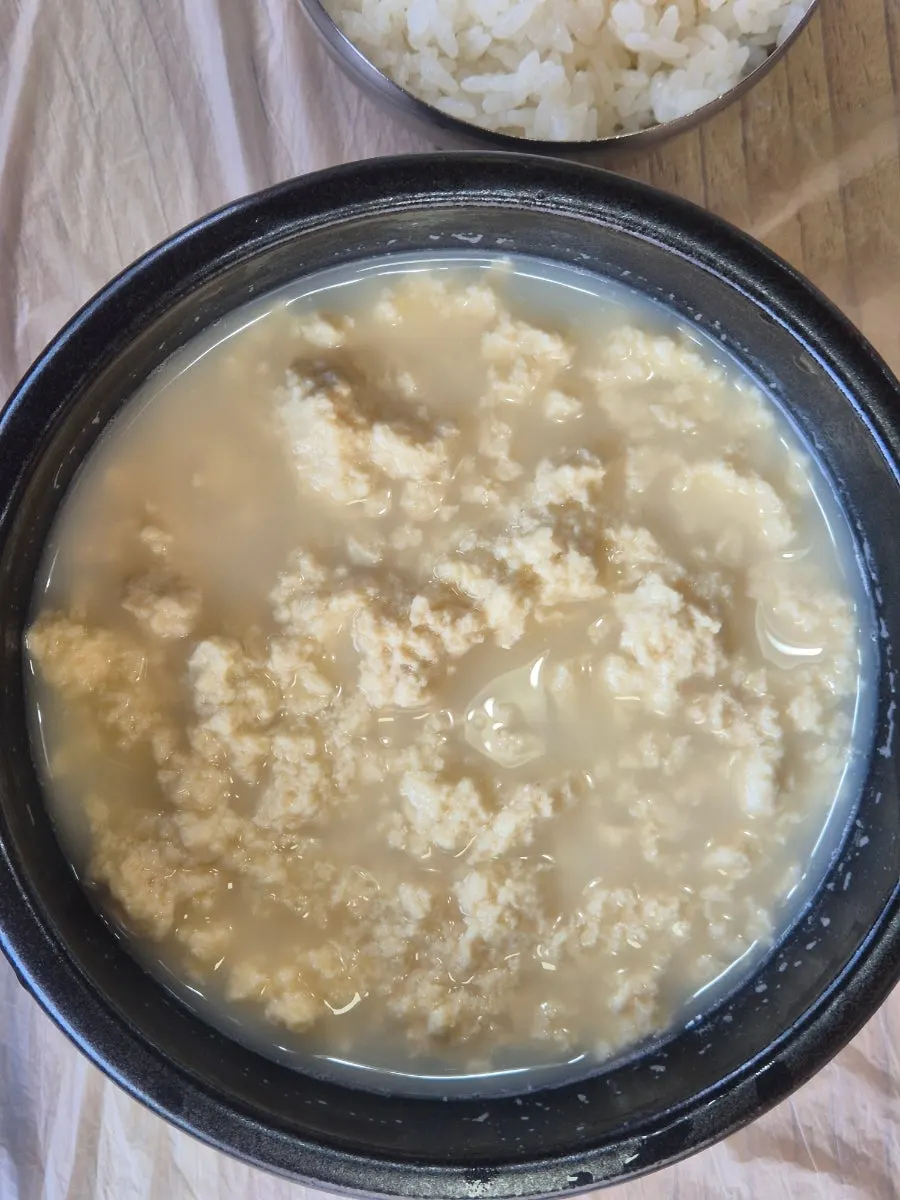 Two bowls of sundubu shared between diners