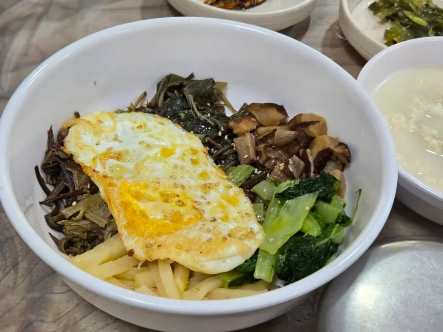 A spoonful of bibimbap with sesame oil aroma