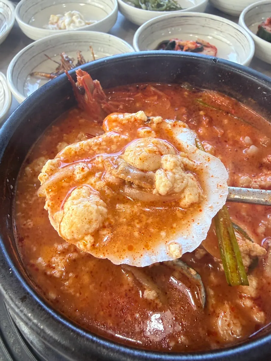 Jjamppong seafood sundubu topped with abalone and shrimp