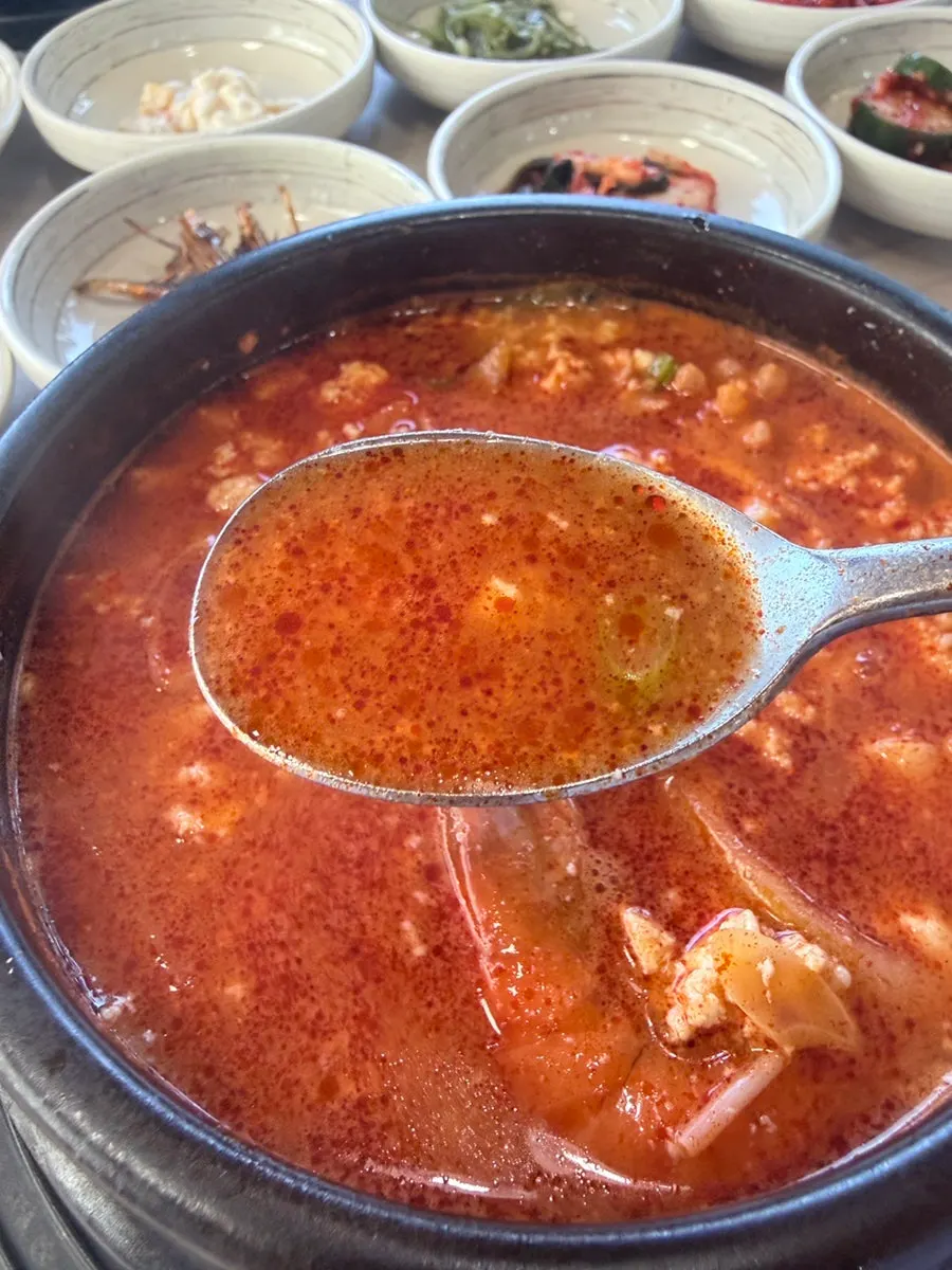 Sundubu stew bubbling in a hot stone bowl