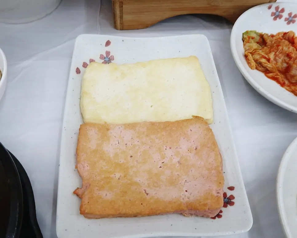Side dishes of pickled vegetables and greens