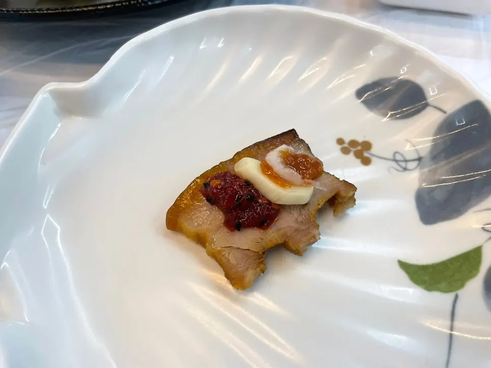 A wrap of suyuk topped with pollack sashimi salad