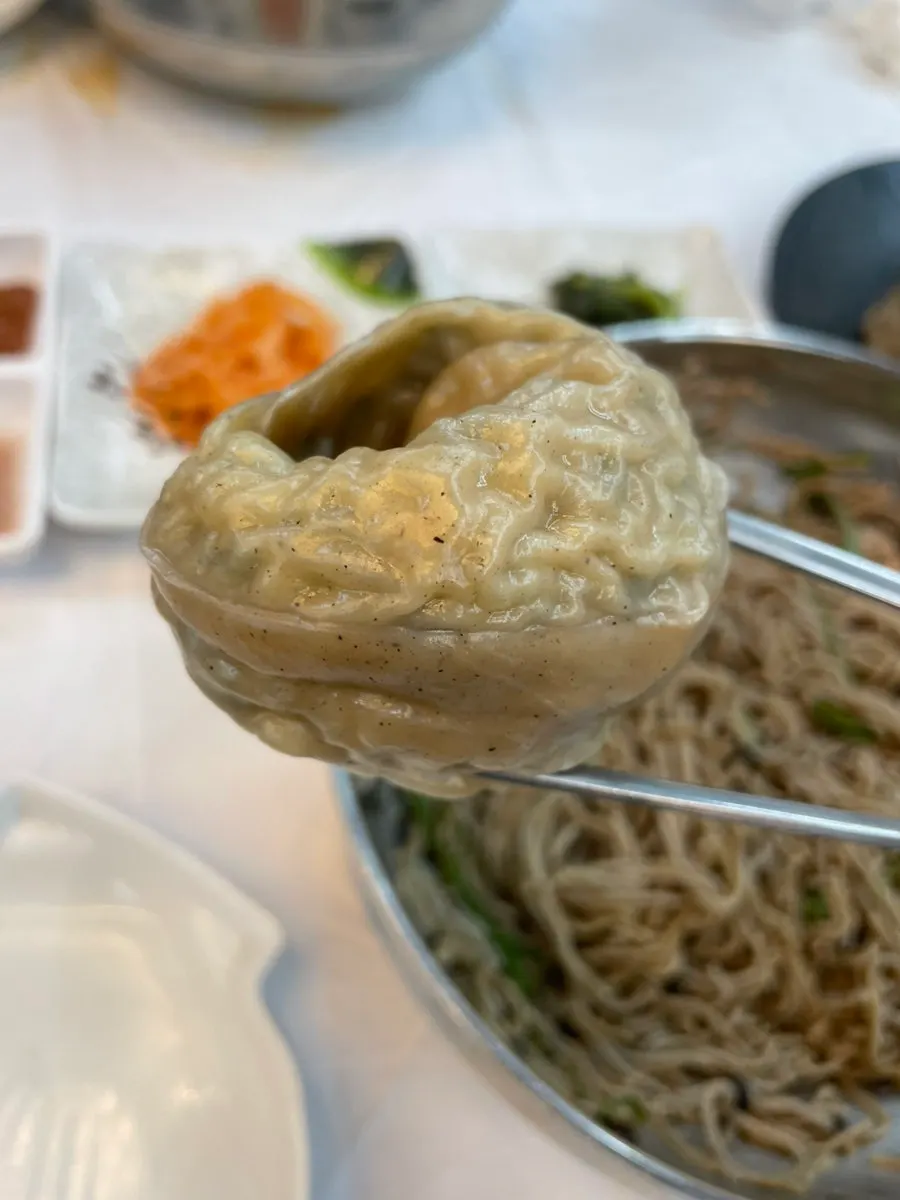 A steaming plate of buckwheat king mandu