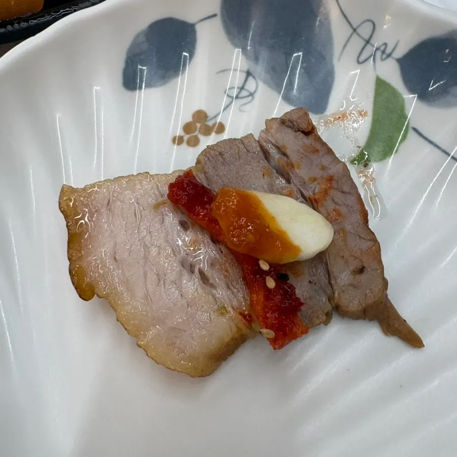 A piece of suyuk topped with pollack salad