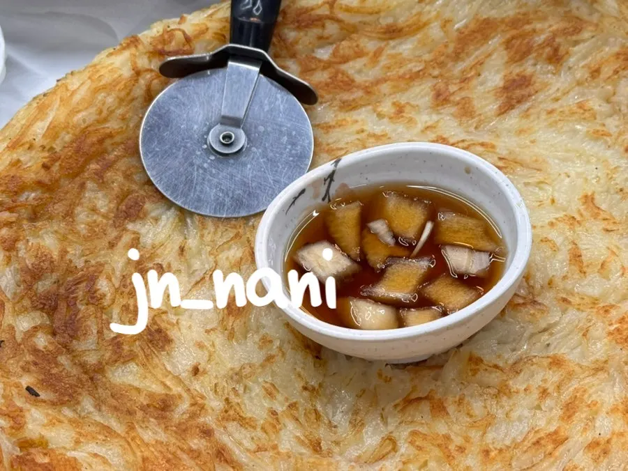 A round, crisply fried potato pancake