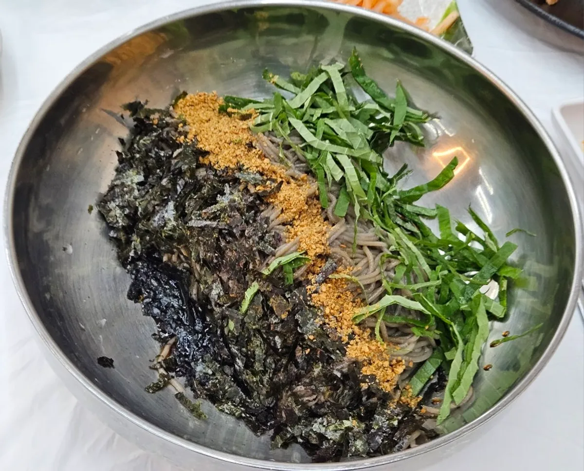 A bowl of deulmemak (perilla oil buckwheat noodles)