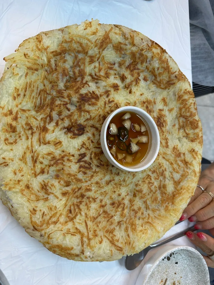 Potato pancake overflowing the plate
