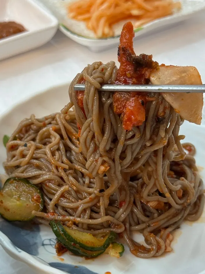 Buckwheat noodles lifted with pollack sashimi on top