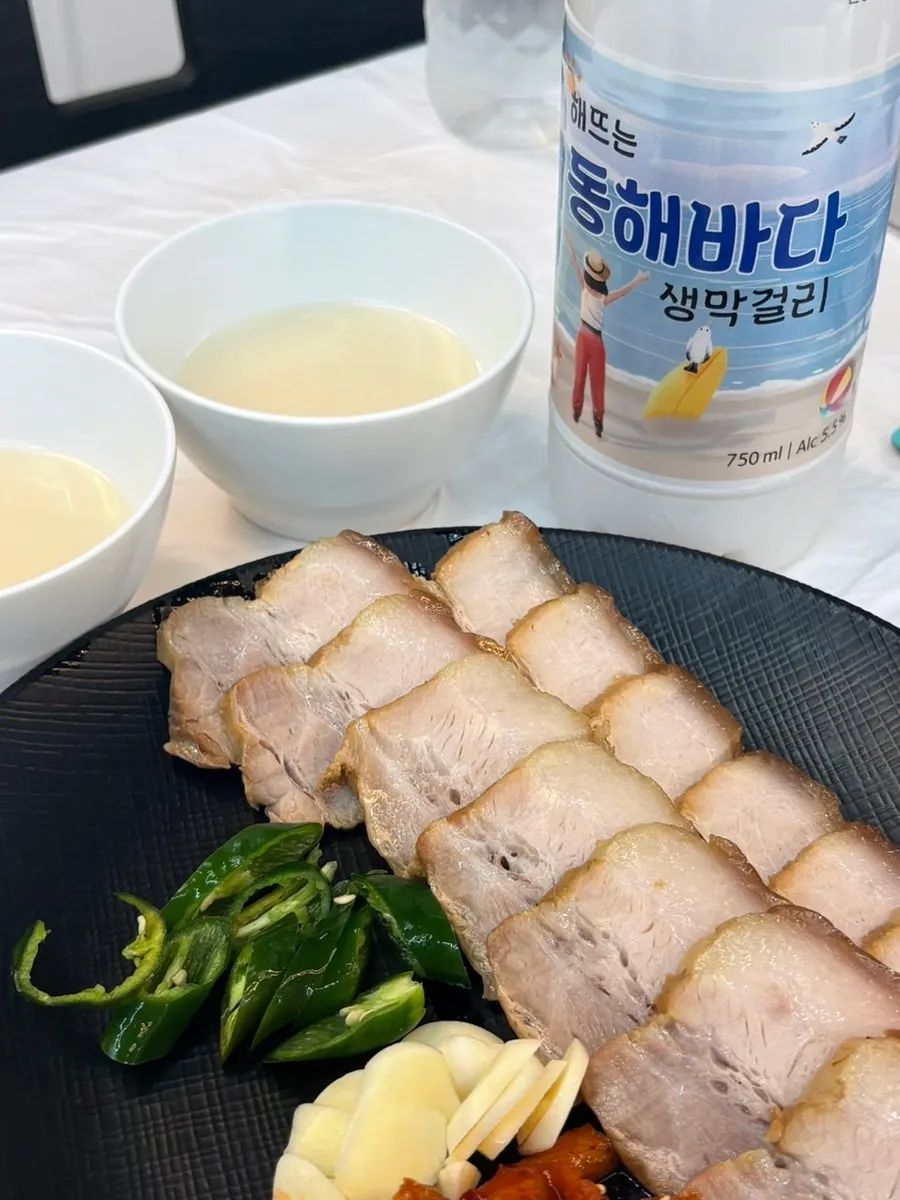 A bite of suyuk topped with garlic, chili, and pollack salad