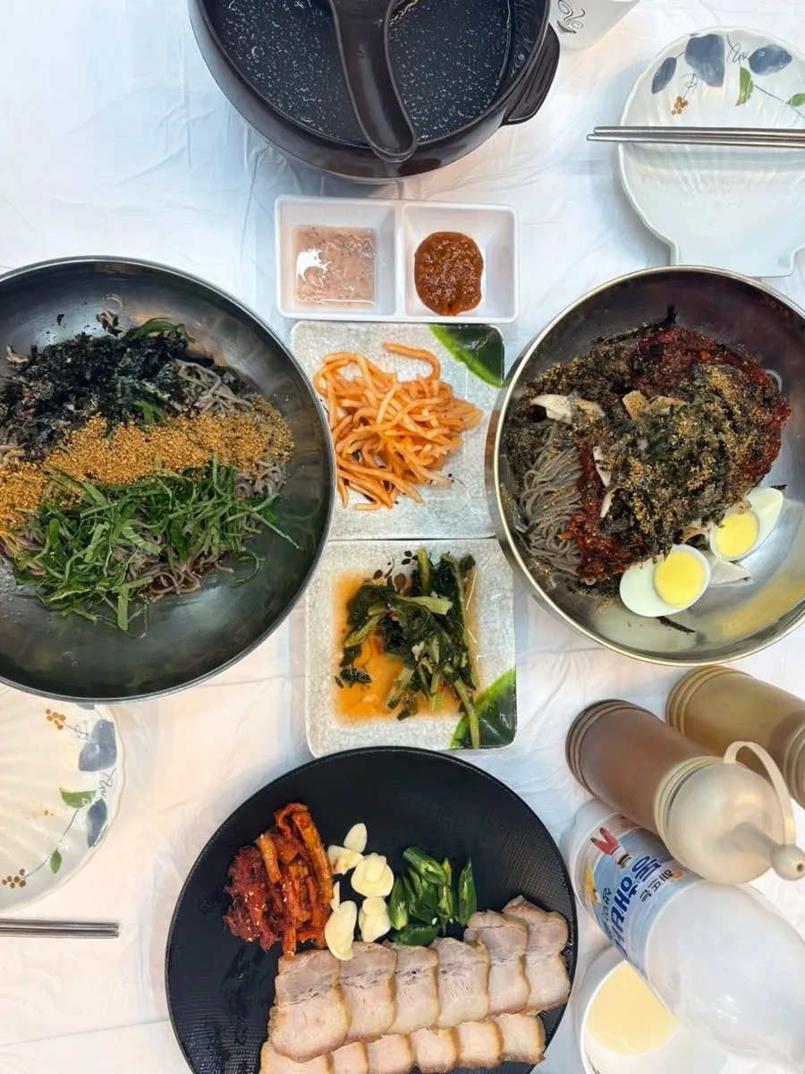 Full table with makguksu, suyuk, and makgeolli all served
