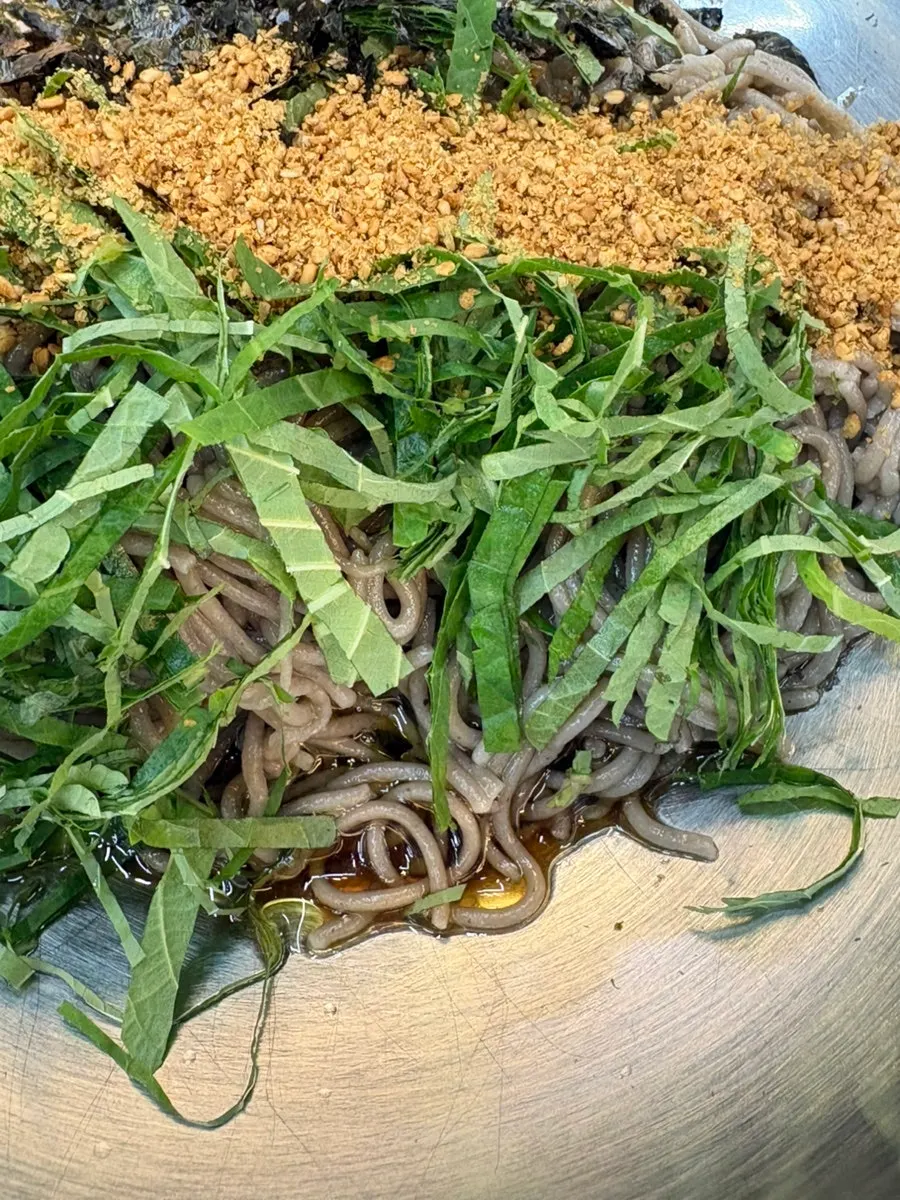 Springy buckwheat noodles lifted with chopsticks