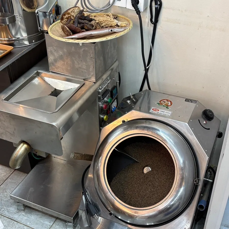 Whole buckwheat grain roaster and grinder inside the restaurant