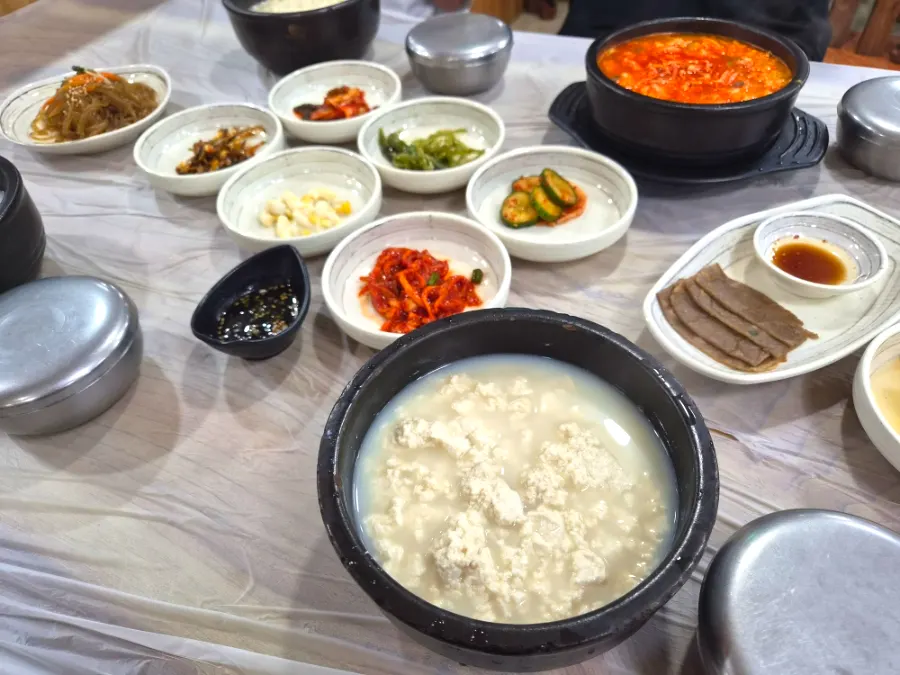 Table spread with Chodang sundubu and spicy sundubu
