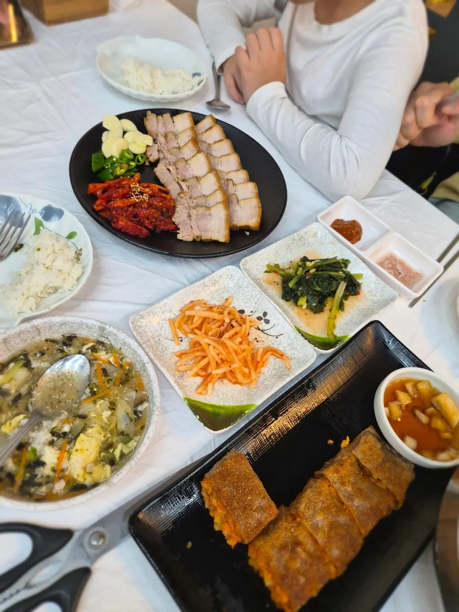 Family table with makguksu and mandu-guk together