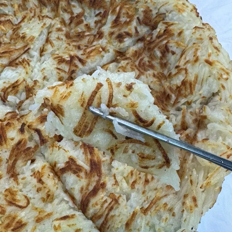 Cross-section of crispy potato pancake made with shredded potato