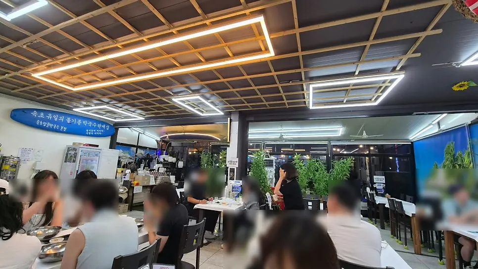 Interior dining hall of Sokcho Topgol Makguksu with generously spaced tables