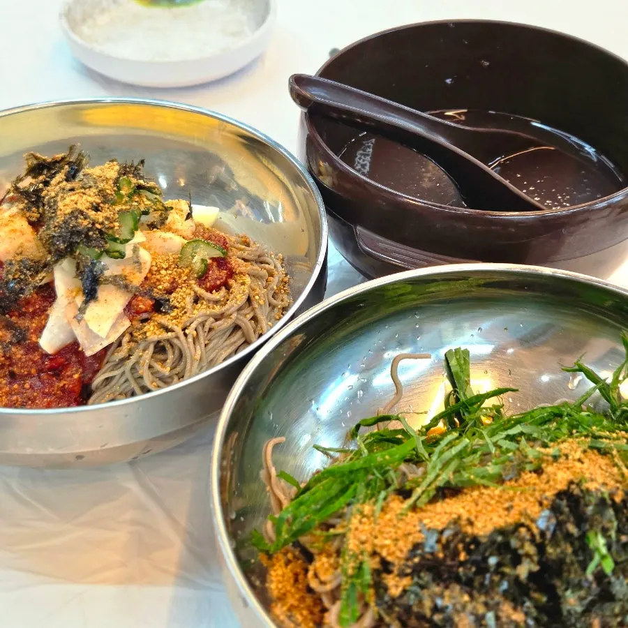 Table spread with makguksu, kalguksu, and king dumpling soup