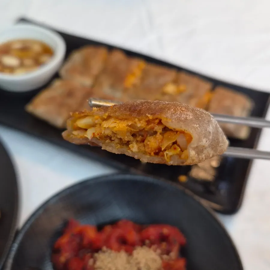 Cross-section of buckwheat jeonbyeong stuffed with kimchi and glass noodles
